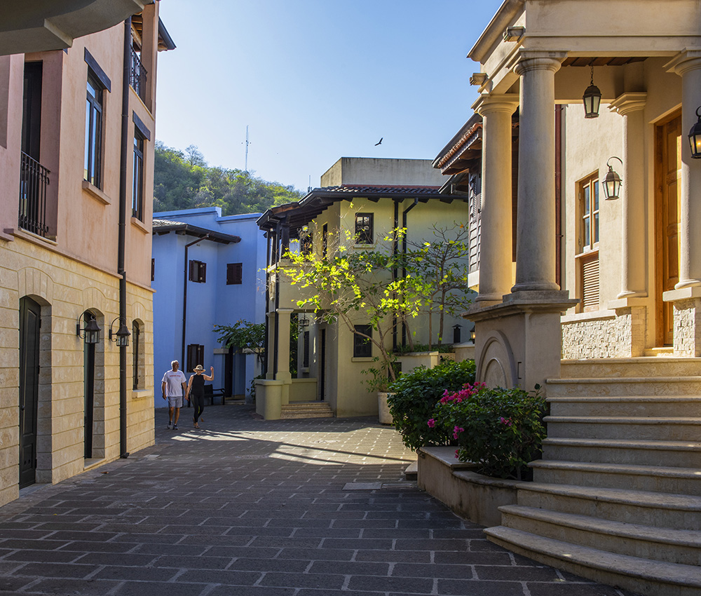 Shaded car-free lanes and shops on the plaza in Las Catalinas